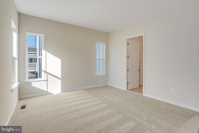 empty room featuring light carpet