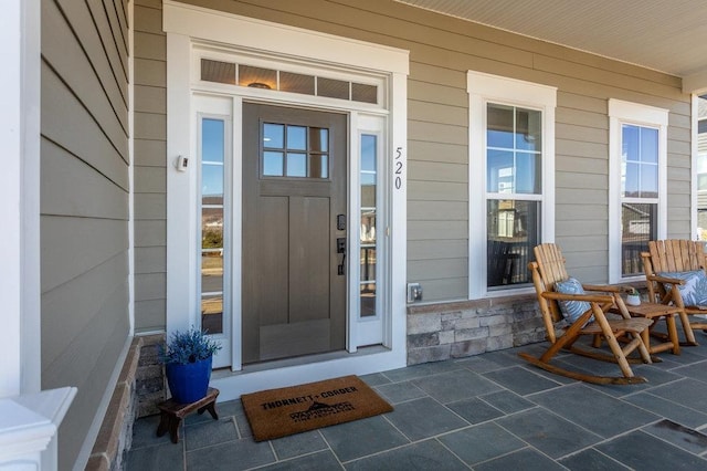 property entrance with covered porch