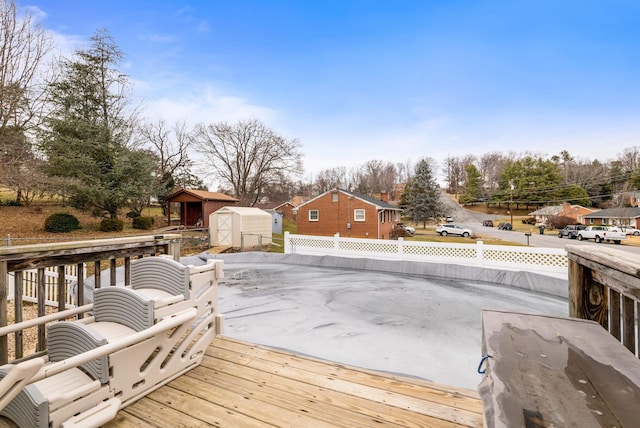 wooden deck featuring a storage shed