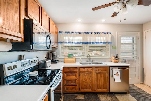 kitchen featuring appliances with stainless steel finishes, sink, and ceiling fan