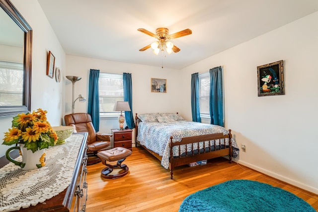 bedroom with light hardwood / wood-style flooring and ceiling fan