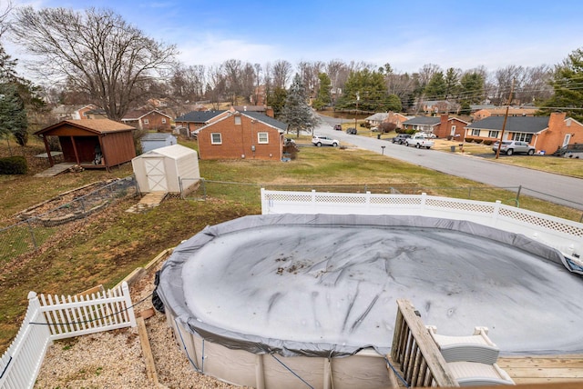 view of swimming pool with a storage unit