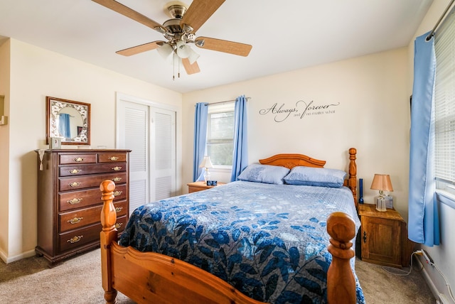 carpeted bedroom with ceiling fan and a closet