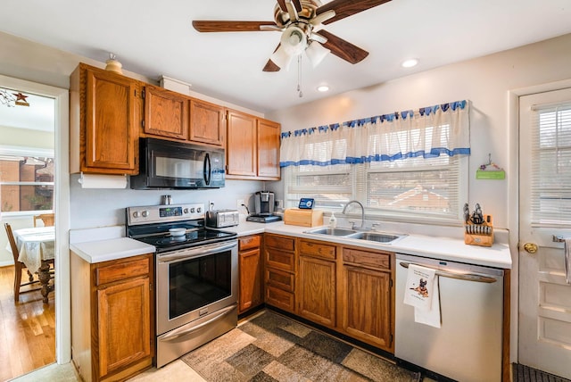 kitchen with ceiling fan, appliances with stainless steel finishes, and sink