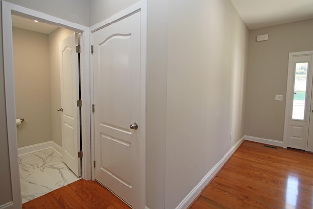 hallway featuring wood-type flooring