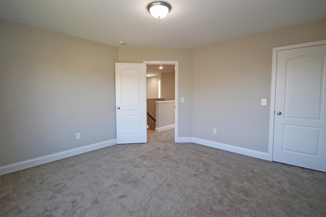 unfurnished bedroom featuring light carpet