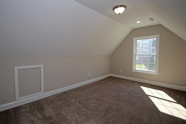 additional living space with vaulted ceiling and carpet flooring