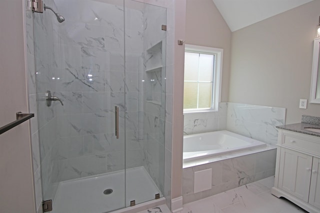 bathroom featuring vanity, vaulted ceiling, and shower with separate bathtub