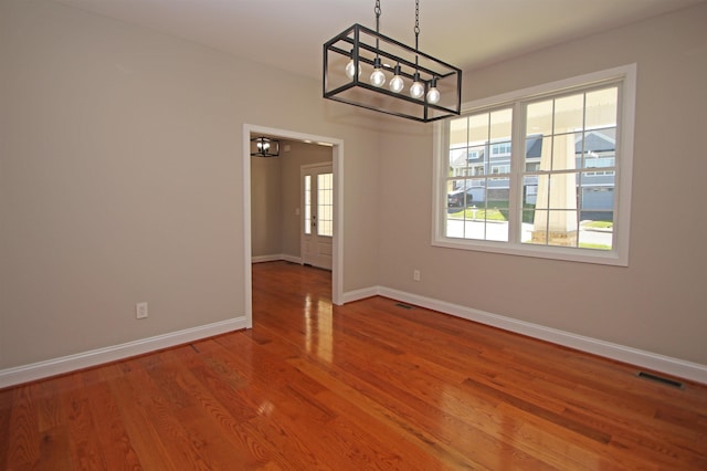 unfurnished dining area featuring hardwood / wood-style floors