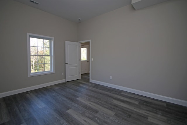 empty room with dark hardwood / wood-style floors