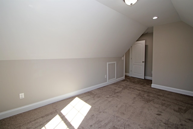 bonus room with lofted ceiling and carpet floors