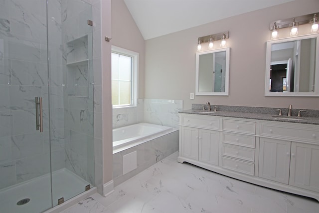 bathroom featuring vanity, separate shower and tub, and vaulted ceiling