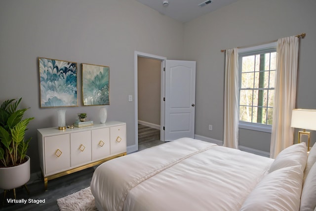 bedroom with dark hardwood / wood-style flooring