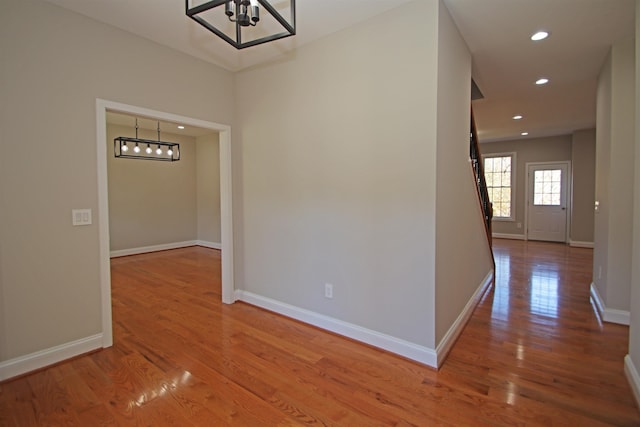 interior space featuring wood-type flooring and a notable chandelier