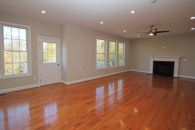 unfurnished living room with hardwood / wood-style floors and ceiling fan