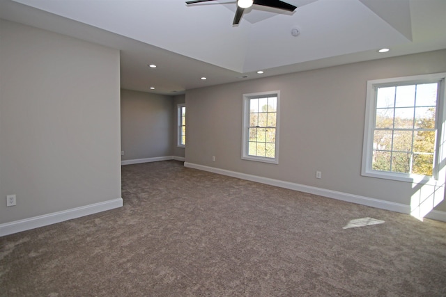 empty room featuring lofted ceiling, carpet flooring, and ceiling fan