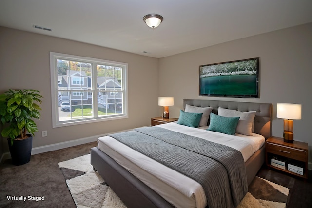 bedroom featuring dark colored carpet