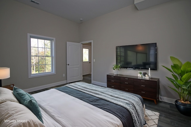 bedroom with dark wood-type flooring