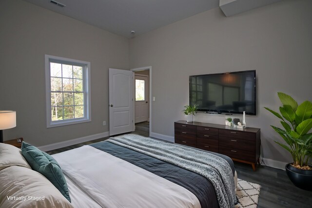 bedroom with dark wood-type flooring