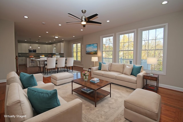 living room featuring ceiling fan and light hardwood / wood-style floors