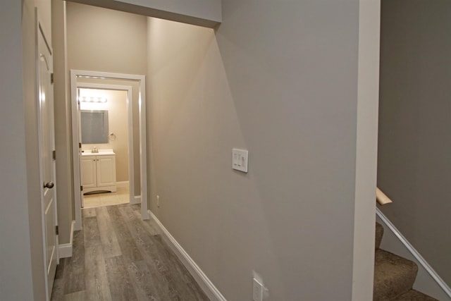 hallway with hardwood / wood-style floors