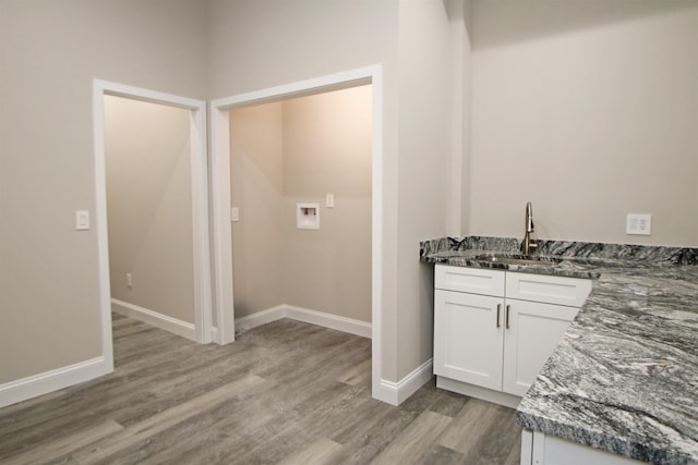 interior space featuring hardwood / wood-style flooring, hookup for a washing machine, and sink