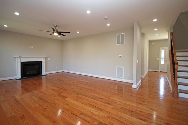 unfurnished living room with ceiling fan and light wood-type flooring