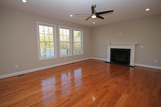 unfurnished living room featuring ceiling fan and light wood-type flooring