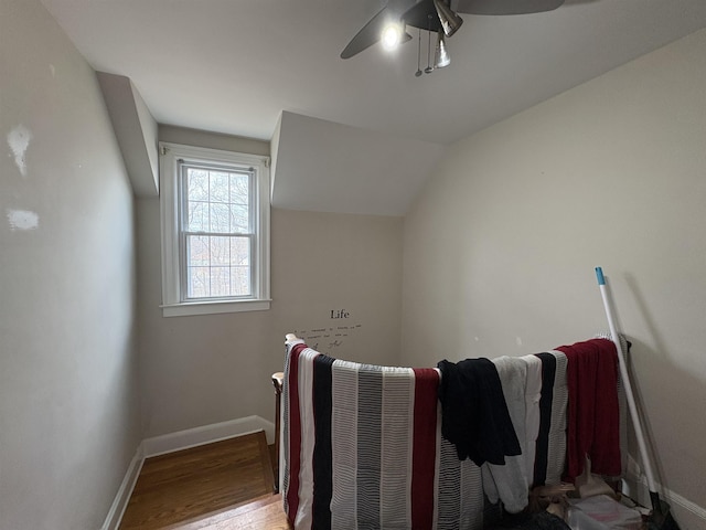 bonus room with vaulted ceiling, ceiling fan, baseboards, and wood finished floors