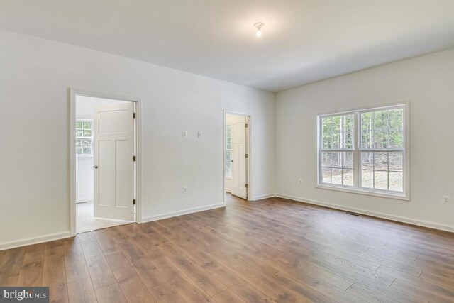 empty room with hardwood / wood-style flooring