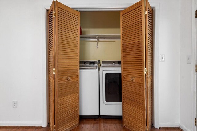laundry room featuring separate washer and dryer, baseboards, laundry area, and dark wood-type flooring