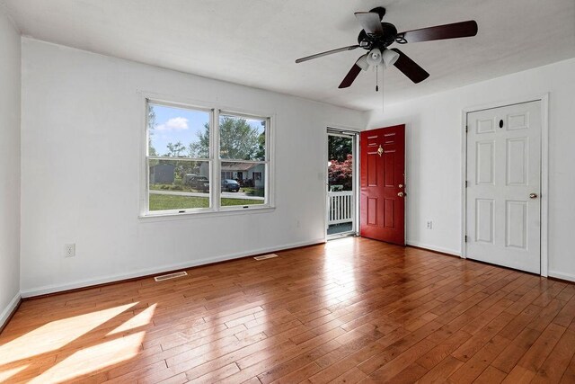 interior space with visible vents, baseboards, and hardwood / wood-style flooring