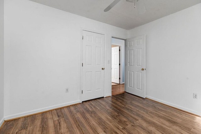 unfurnished bedroom with baseboards, ceiling fan, and wood finished floors