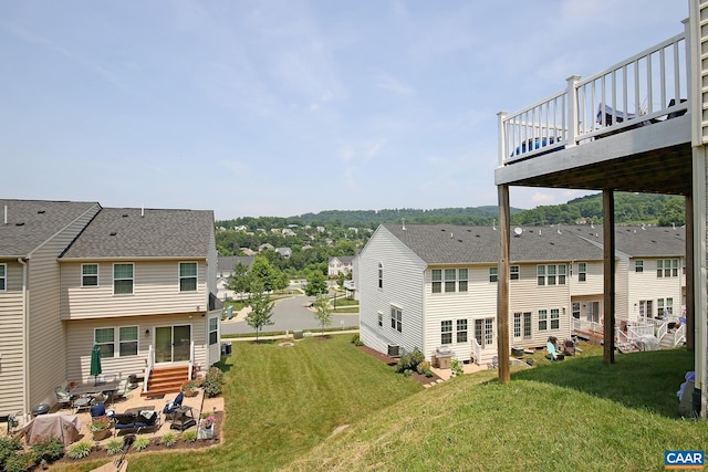 exterior space with a wooden deck, entry steps, a patio area, and a residential view