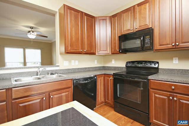 kitchen with a sink, black appliances, light wood-type flooring, ceiling fan, and ornamental molding