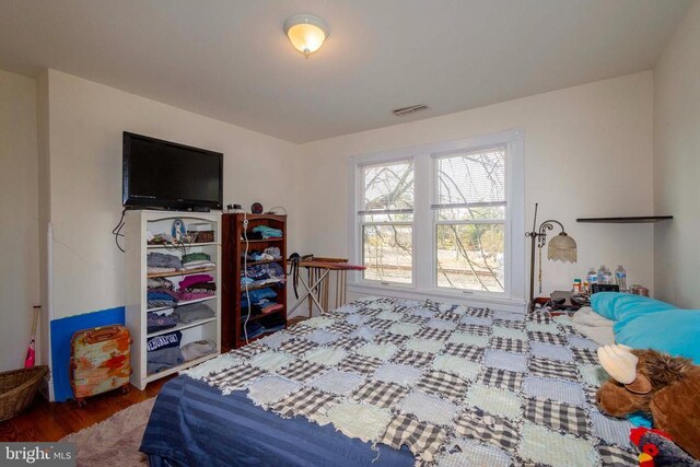 bedroom with wood-type flooring