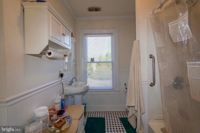 bathroom with sink and ornamental molding