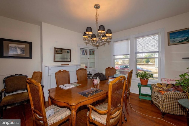 dining area with wood-type flooring and a chandelier