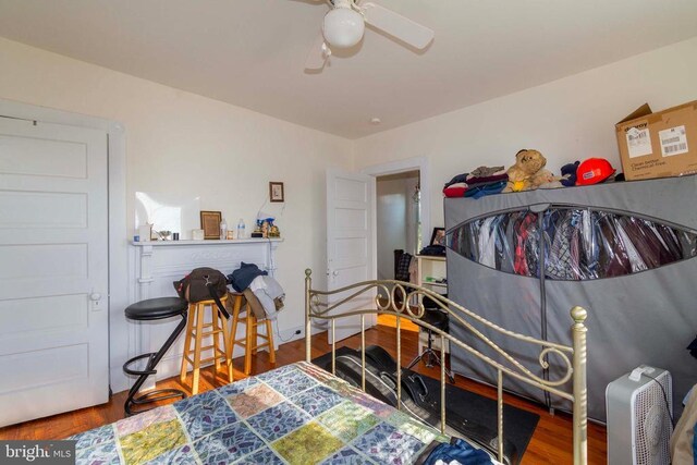 bedroom with ceiling fan and hardwood / wood-style floors