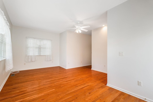 unfurnished room with ceiling fan and light hardwood / wood-style floors