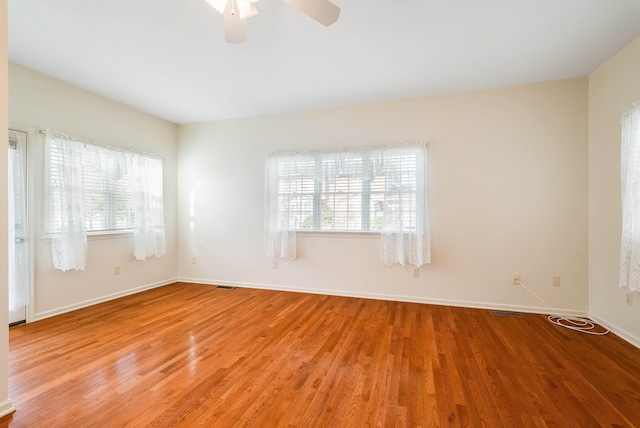 empty room featuring ceiling fan and light wood-type flooring