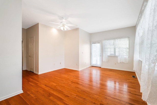 empty room with hardwood / wood-style flooring and ceiling fan