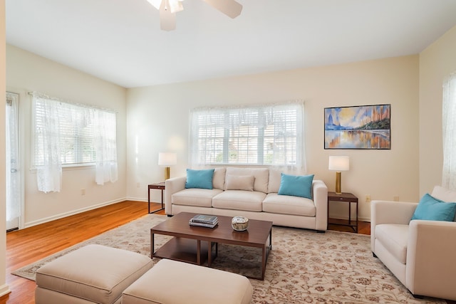 living room featuring ceiling fan and light wood-type flooring