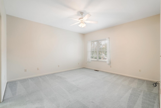 empty room with light colored carpet and ceiling fan