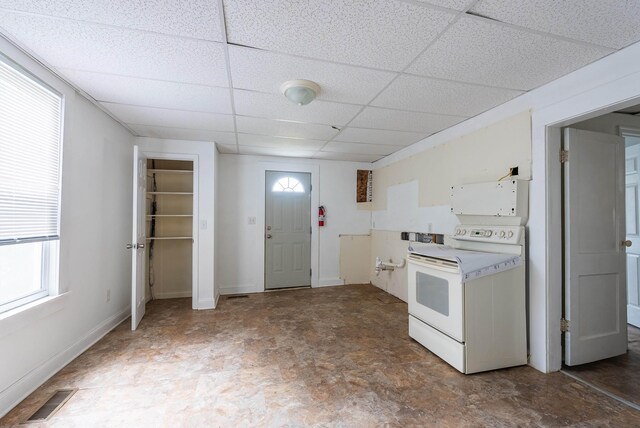 kitchen with a paneled ceiling and white electric range oven