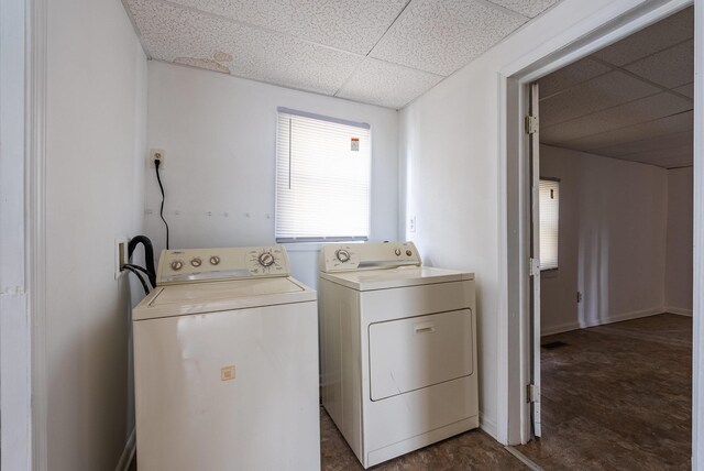 clothes washing area with washing machine and dryer