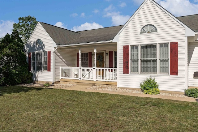 view of front of home with a porch, a shingled roof, and a front lawn