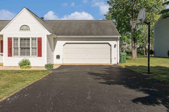 ranch-style house featuring an attached garage, driveway, a shingled roof, and a front lawn