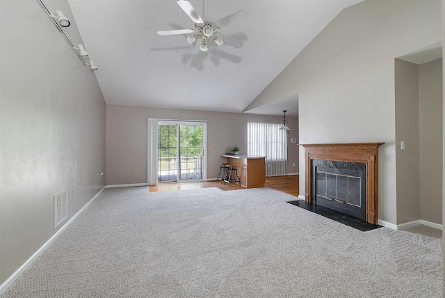 unfurnished living room with visible vents, carpet flooring, baseboards, and ceiling fan
