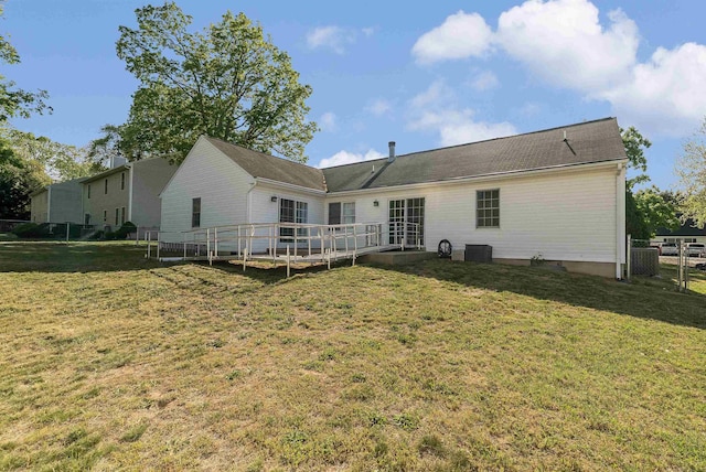 rear view of property featuring central AC, a wooden deck, a yard, and fence